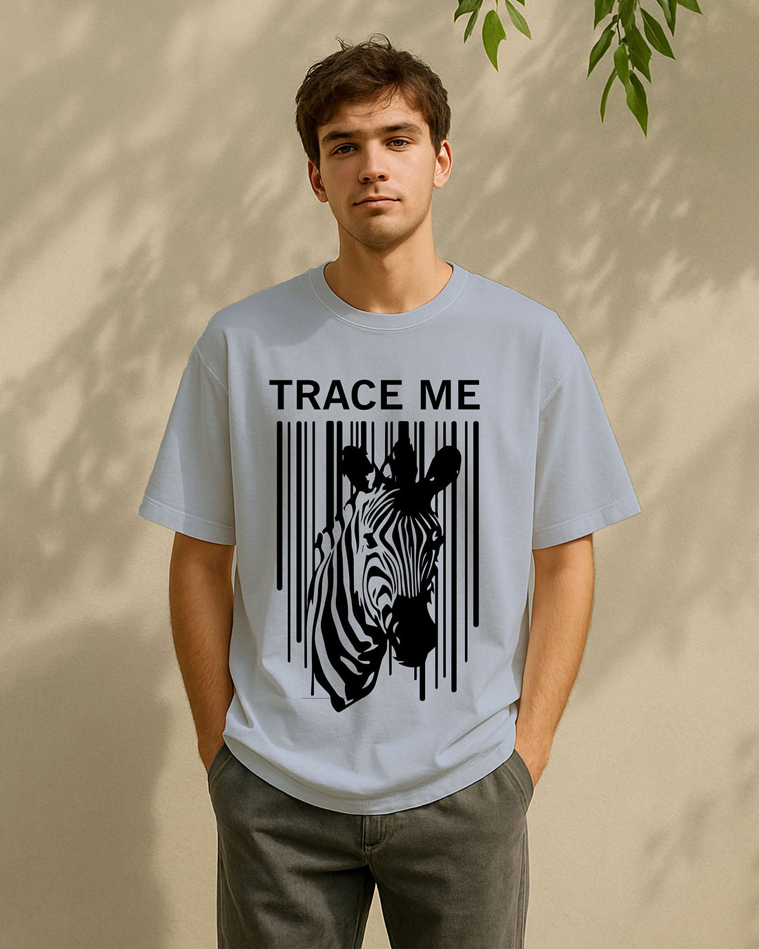 Person wearing a  Dumkee Oversize light gray t-shirt with a zebra graphic and 'TRACE ME'
