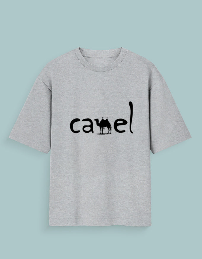 Person wearing a Dumkee Oversize gray t-shirt with 'camel' logo against a dark background