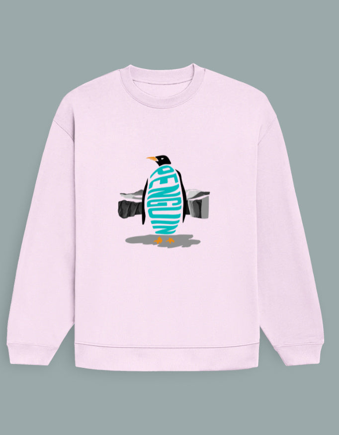 Person wearing a Dumkee Oversize pink sweatshirt with a penguin design in an urban setting