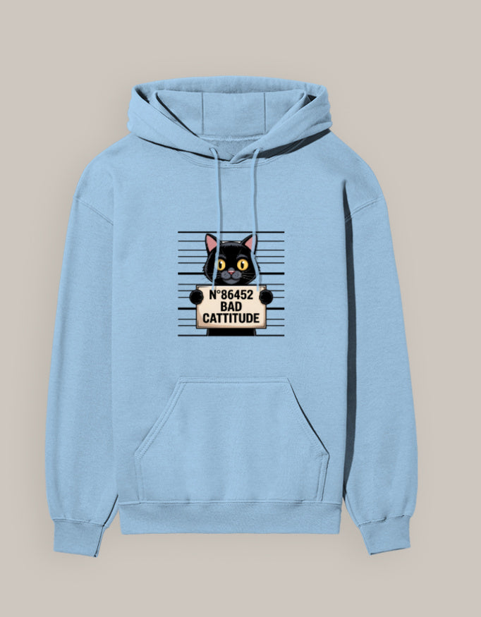 Woman wearing a Dumkee light blue hoodie with a cat graphic and text