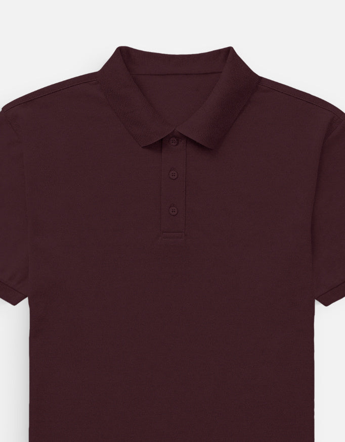 Man wearing a Dumkee  maroon polo shirt and beige pants
