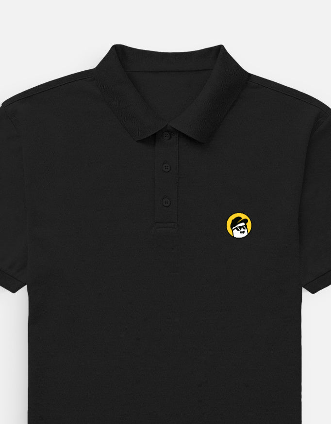 Man wearing a Dumkee black polo shirt with a yellow logo