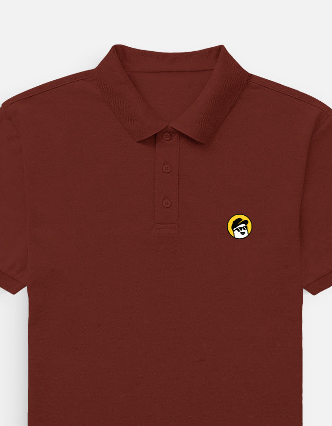 Man wearing a Dumkee brown polo shirt with a logo