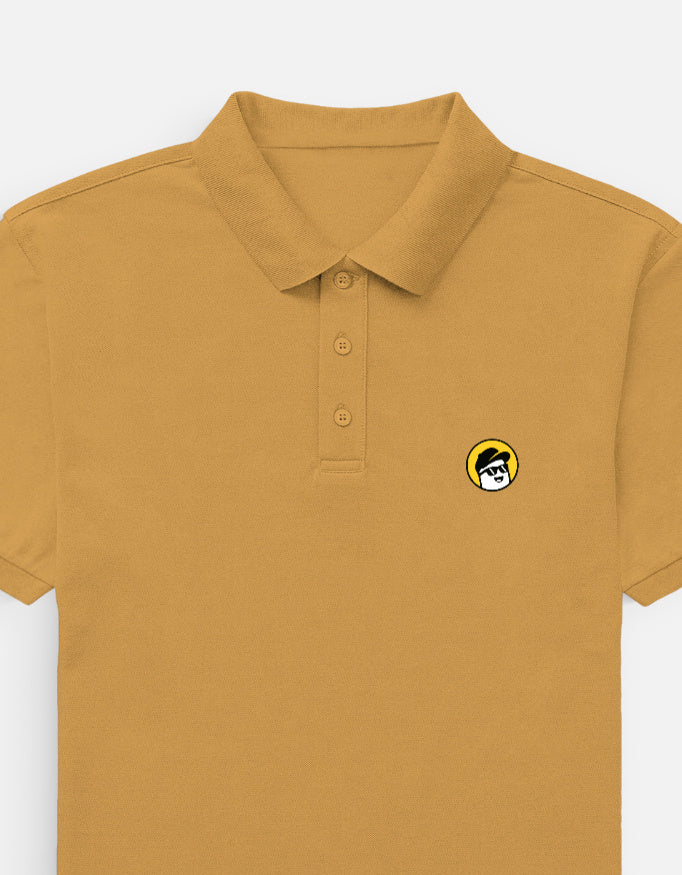 Man wearing a Dumkee  mustard yellow polo shirt and light gray shorts