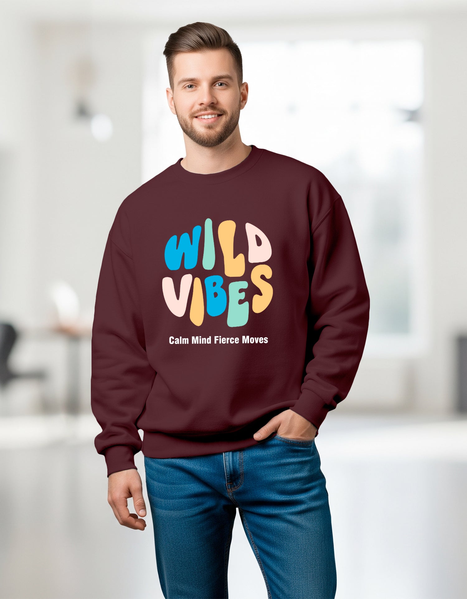 Man wearing a Dumkee Oversize maroon sweatshirt with 'Wild Vibes' text in colorful letters.