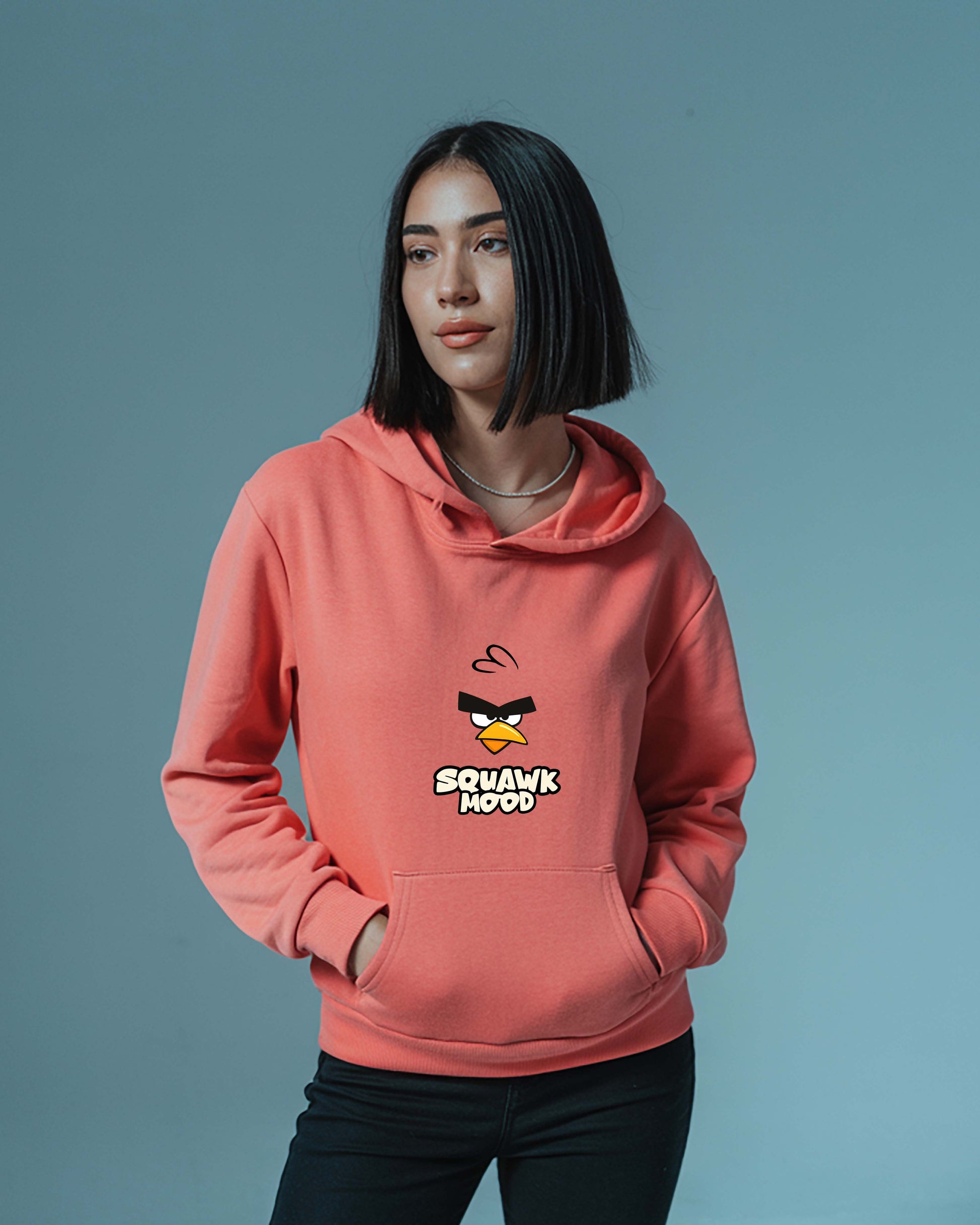 Women wearing a Dumkee coral hoodie with angry bird design on it. 