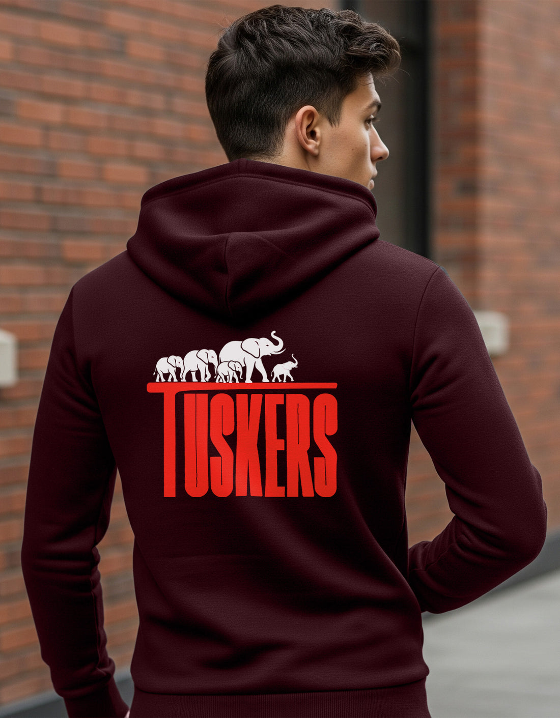 Person wearing a Dumkee maroon hoodie with 'Tuskers' design on the back.