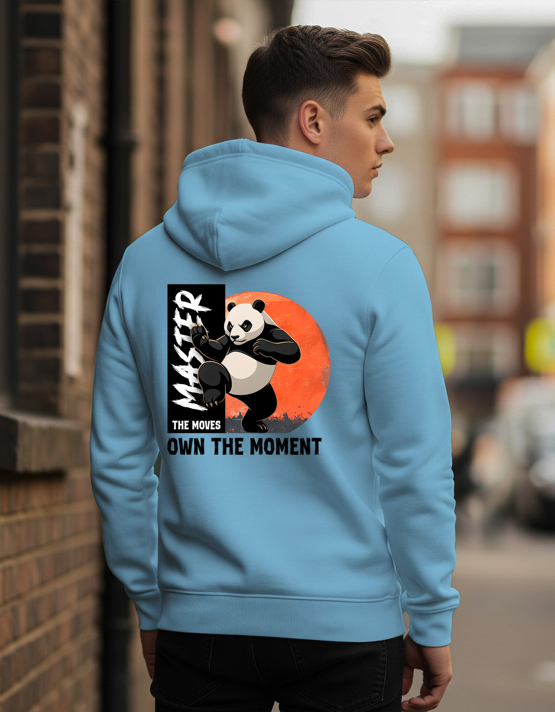 Person wearing a Dumkee Oversize blue hoodie with a panda graphic and text on the back