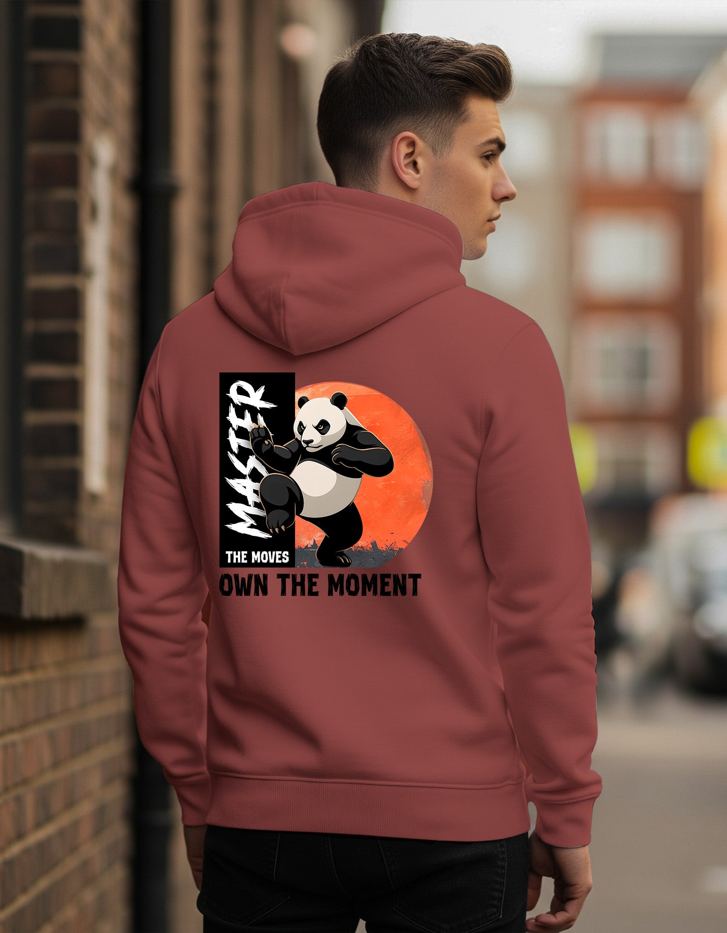 Person wearing a Dumkee Oversize maroon hoodie with a panda graphic and text on the back.