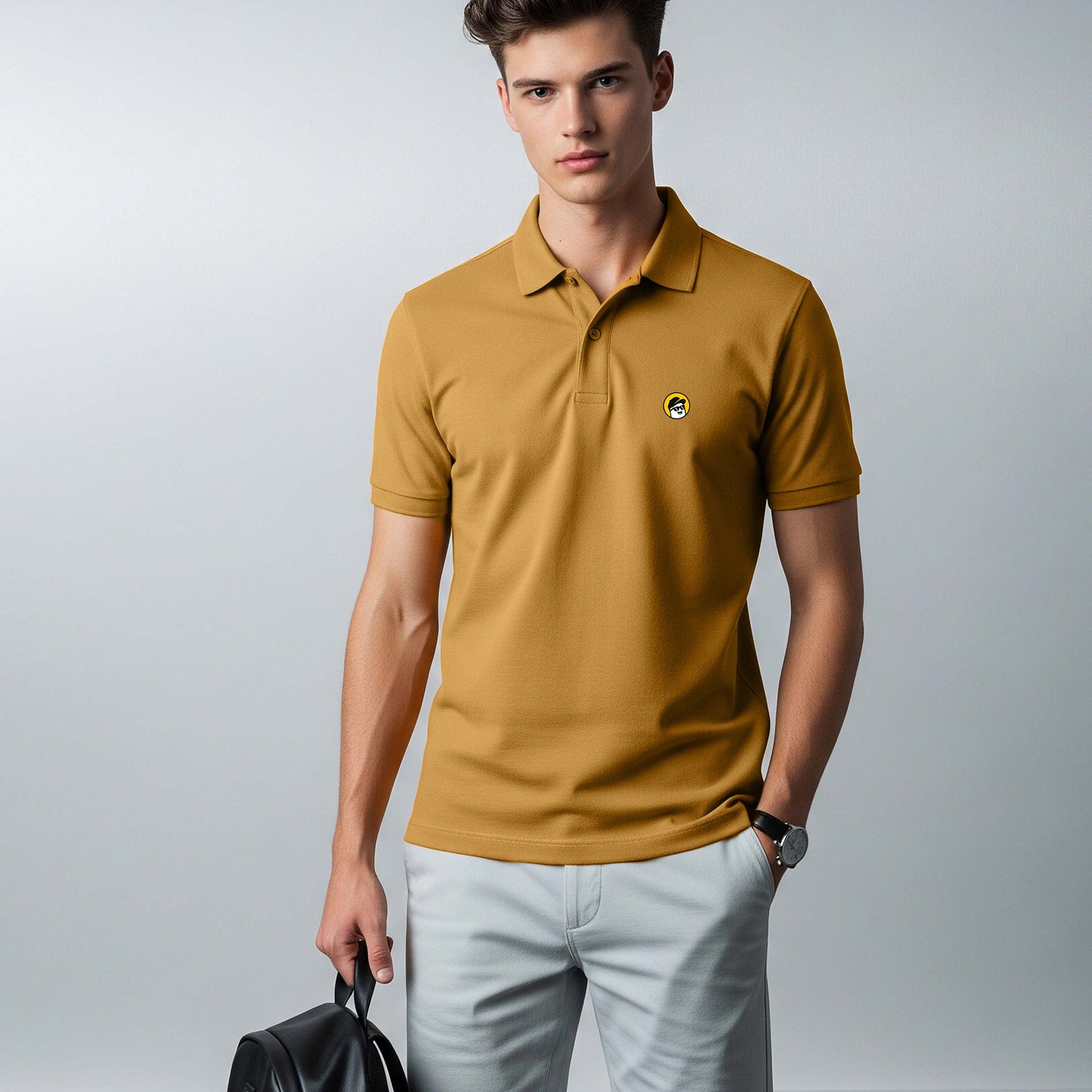 Man wearing a Dumkee  mustard yellow polo shirt and light gray shorts