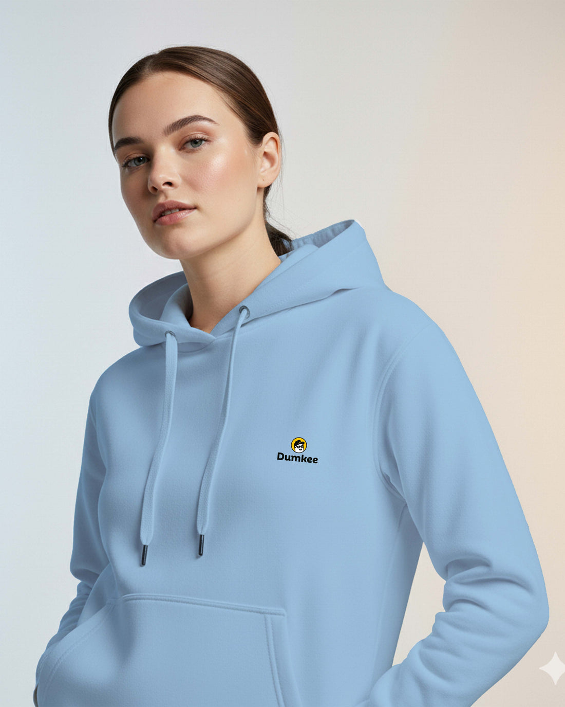 Two people wearing Dumkee  babyblue hoodies with a logo on a city street.