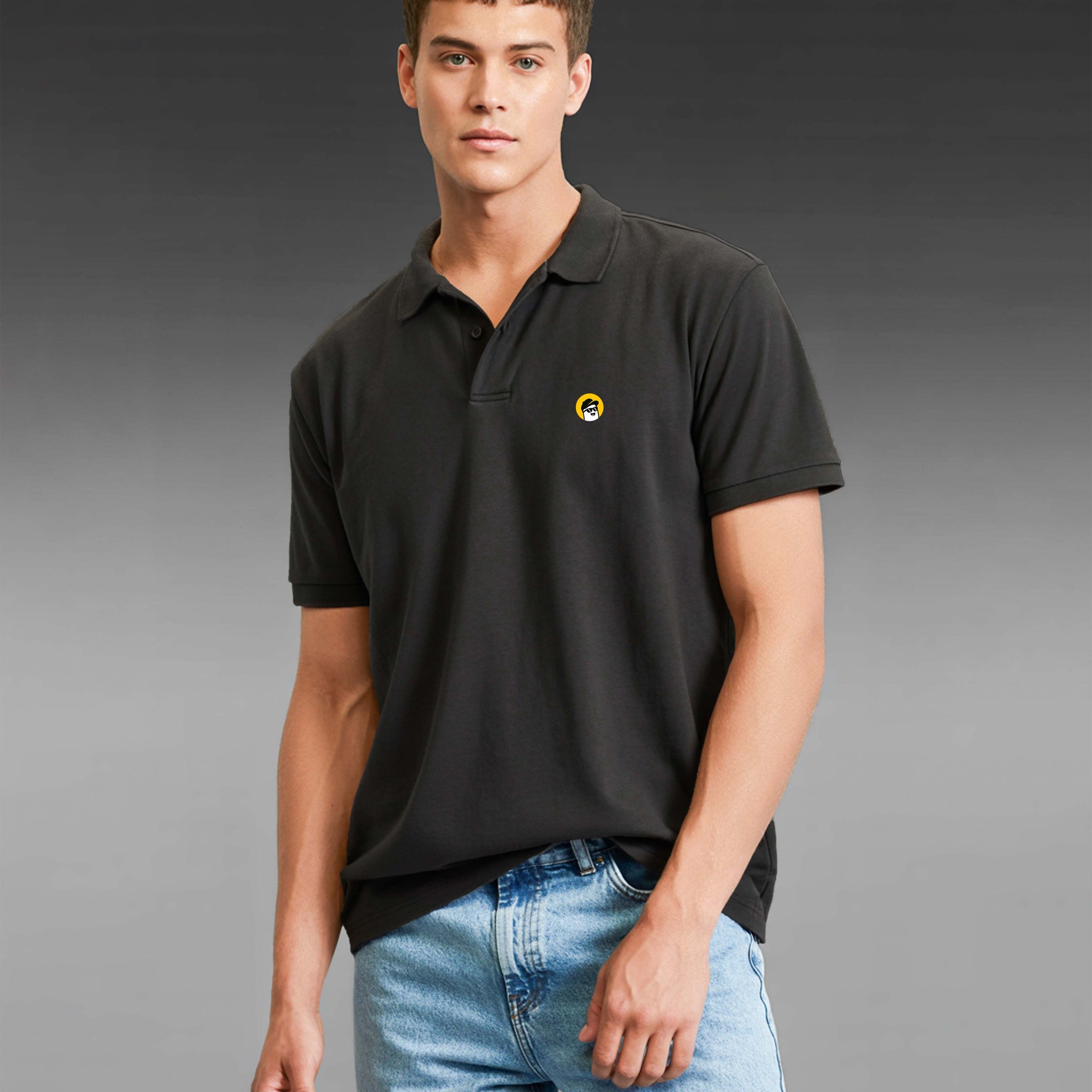 Man wearing a Dumkee black polo shirt with a yellow logo