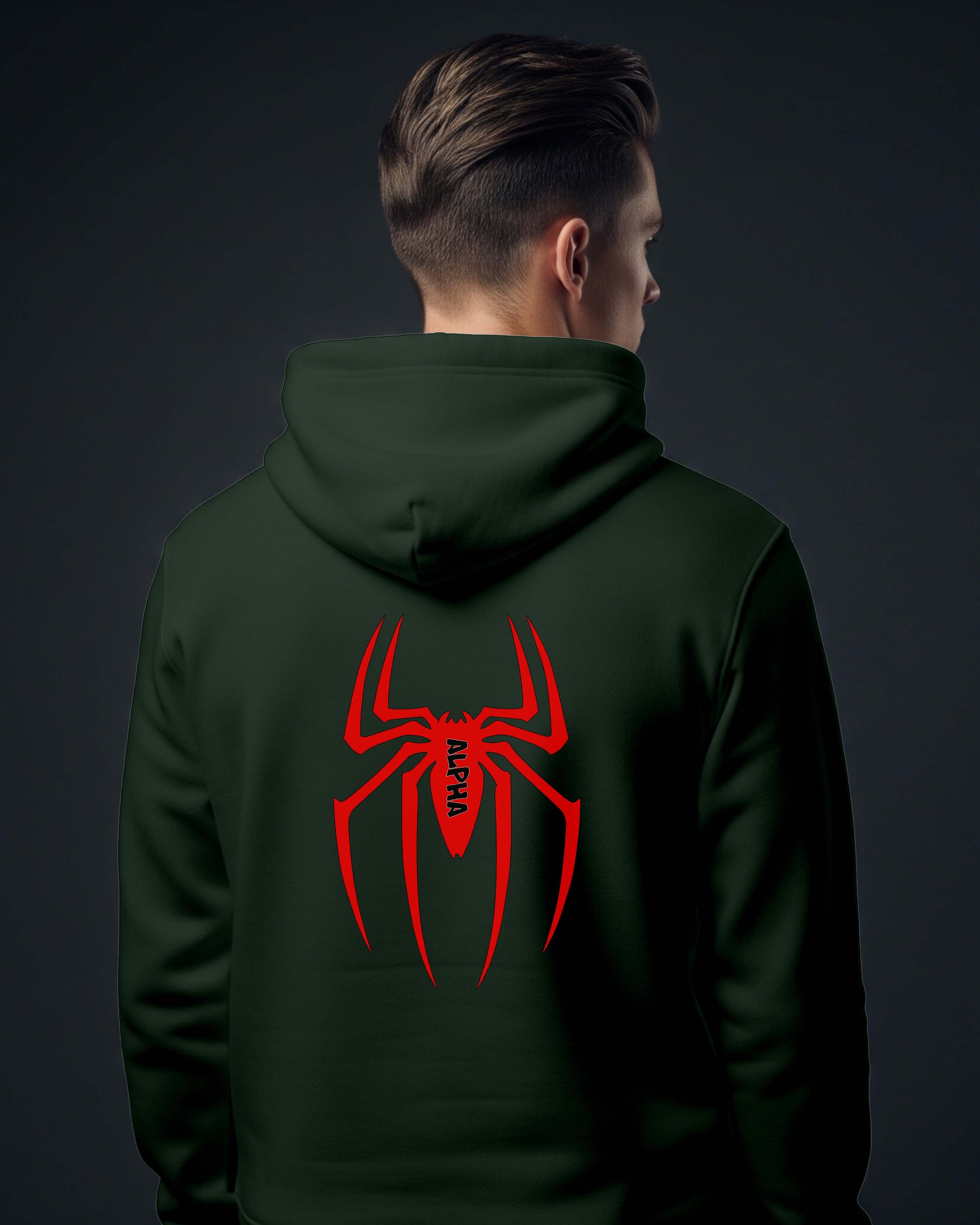 Person wearing a Dumkee dark green hoodie with a red spider logo on the back against a dark background