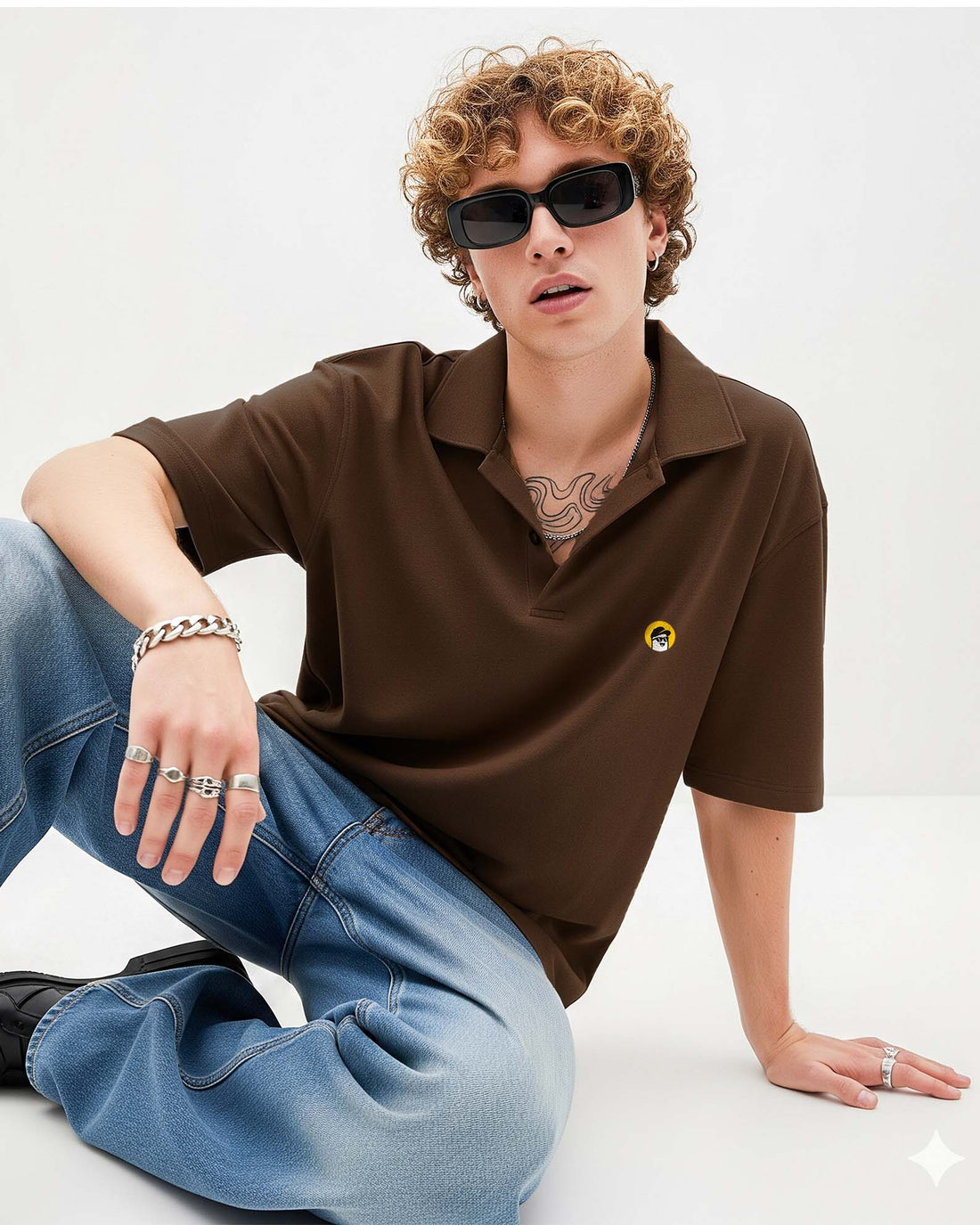Person wearing a  brown polo shirt with a logo