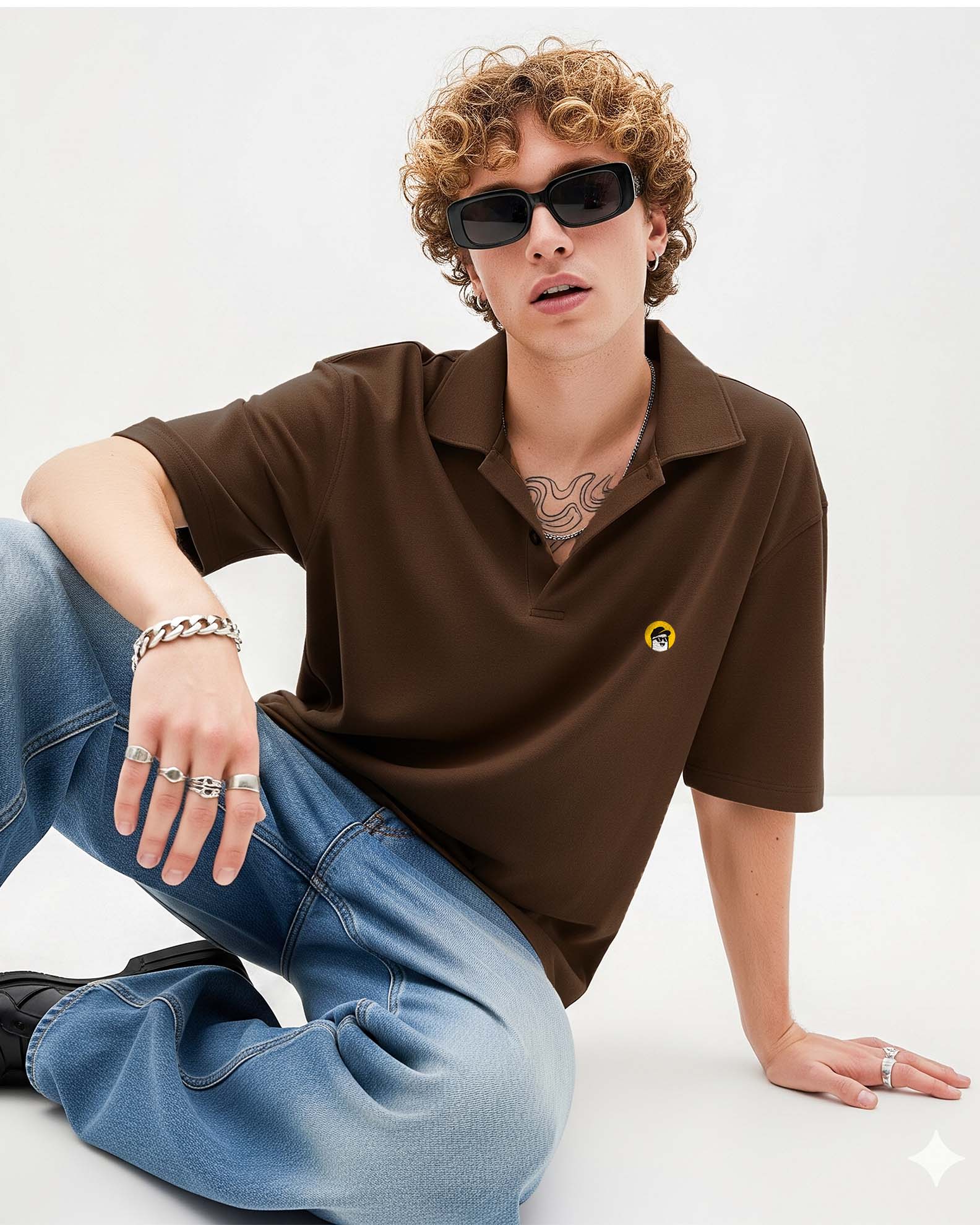 Person wearing a  brown polo shirt with a logo