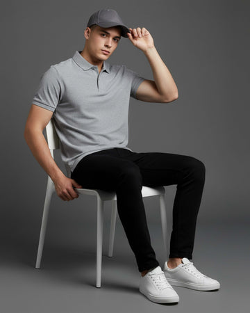 Man sitting on a chair wearing Dumkee gray polo shirt