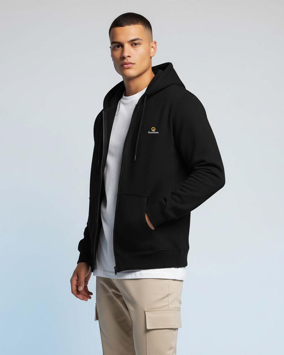 Man wearing a Dumkee black hoodie with a logo.