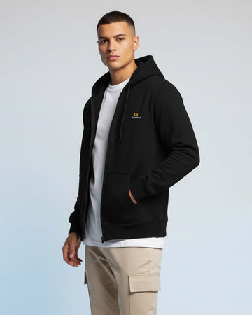 Man wearing a Dumkee black hoodie with a logo.