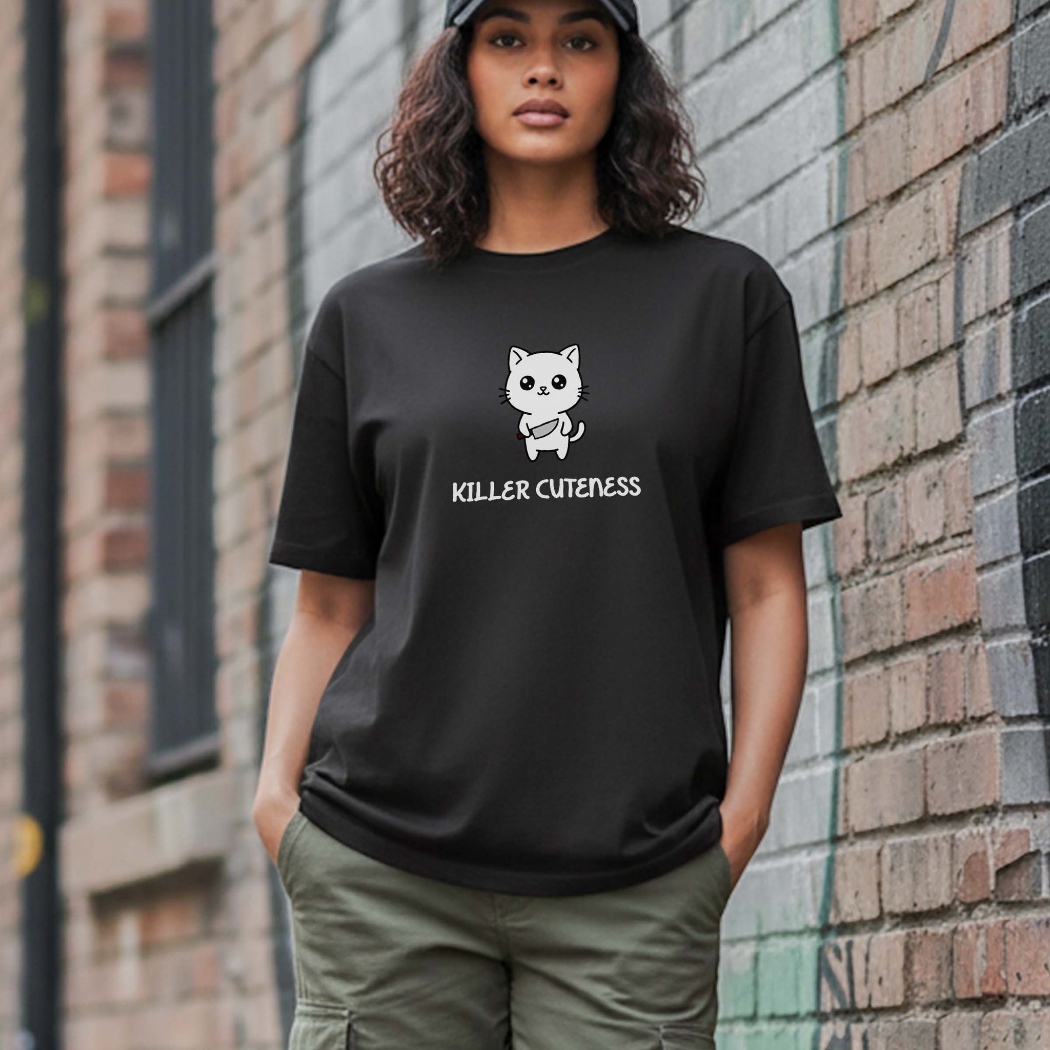 Person wearing a Dumkee Oversize black t-shirt with a killer cat graphic design