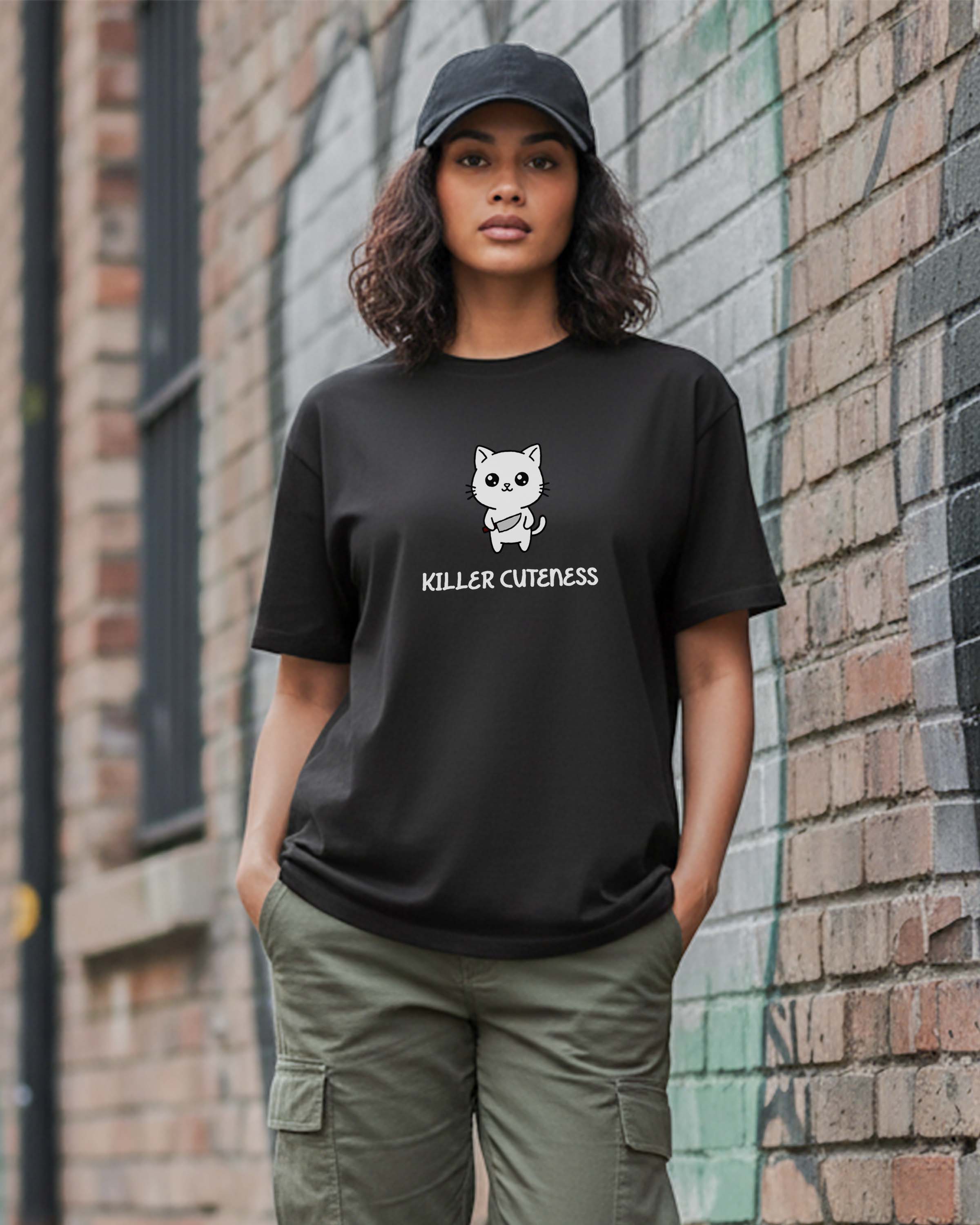 Person wearing a Dumkee Oversize black t-shirt with a killer cat graphic design