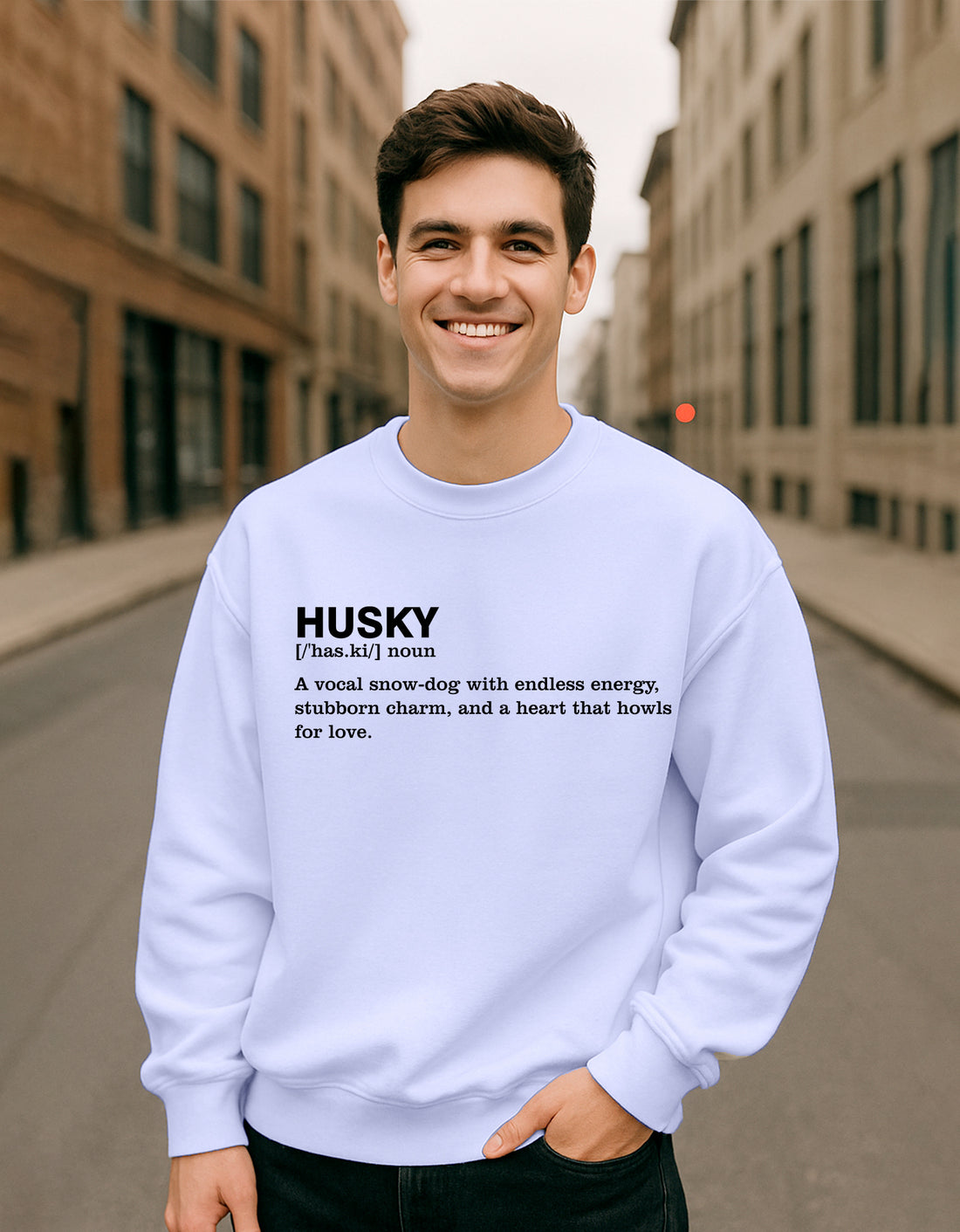Man wearing a Dumkee Oversize light blue sweatshirt with text on a city street