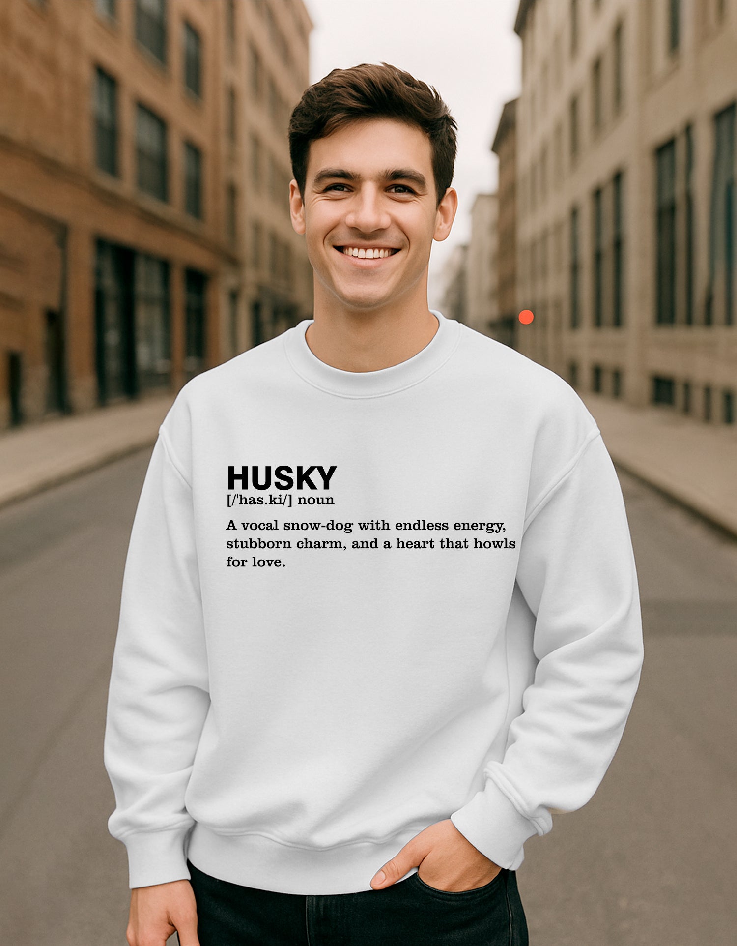Man wearing a Dumkee Oversize white sweatshirt with text on a city street