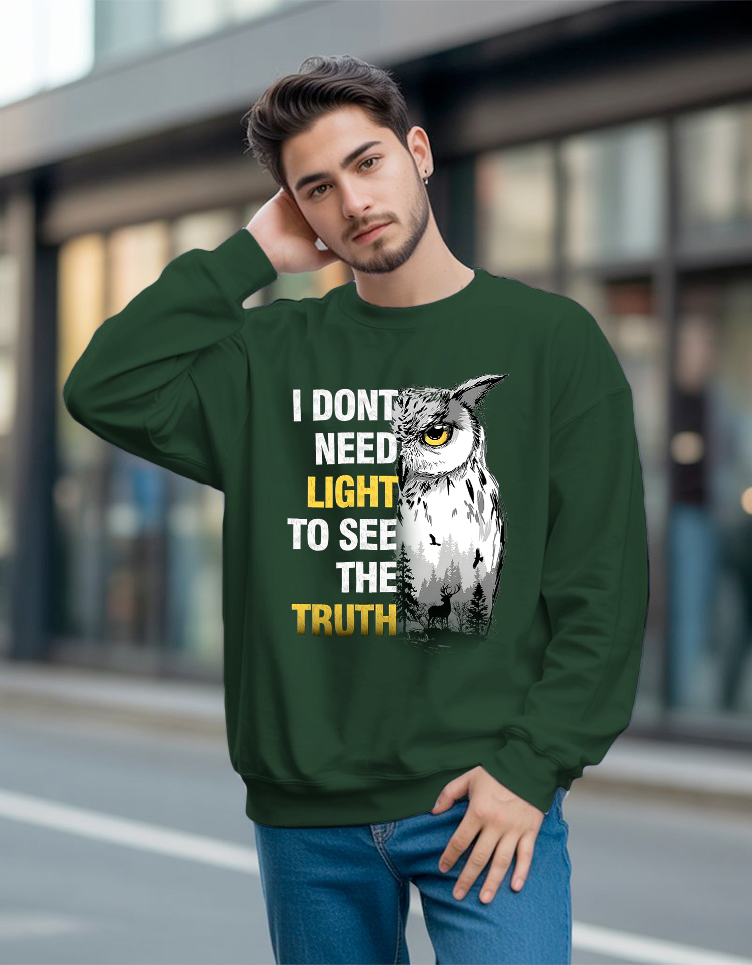 Man wearing a green  Dumkee sweatshirt with an owl graphic and text on a blurred street background