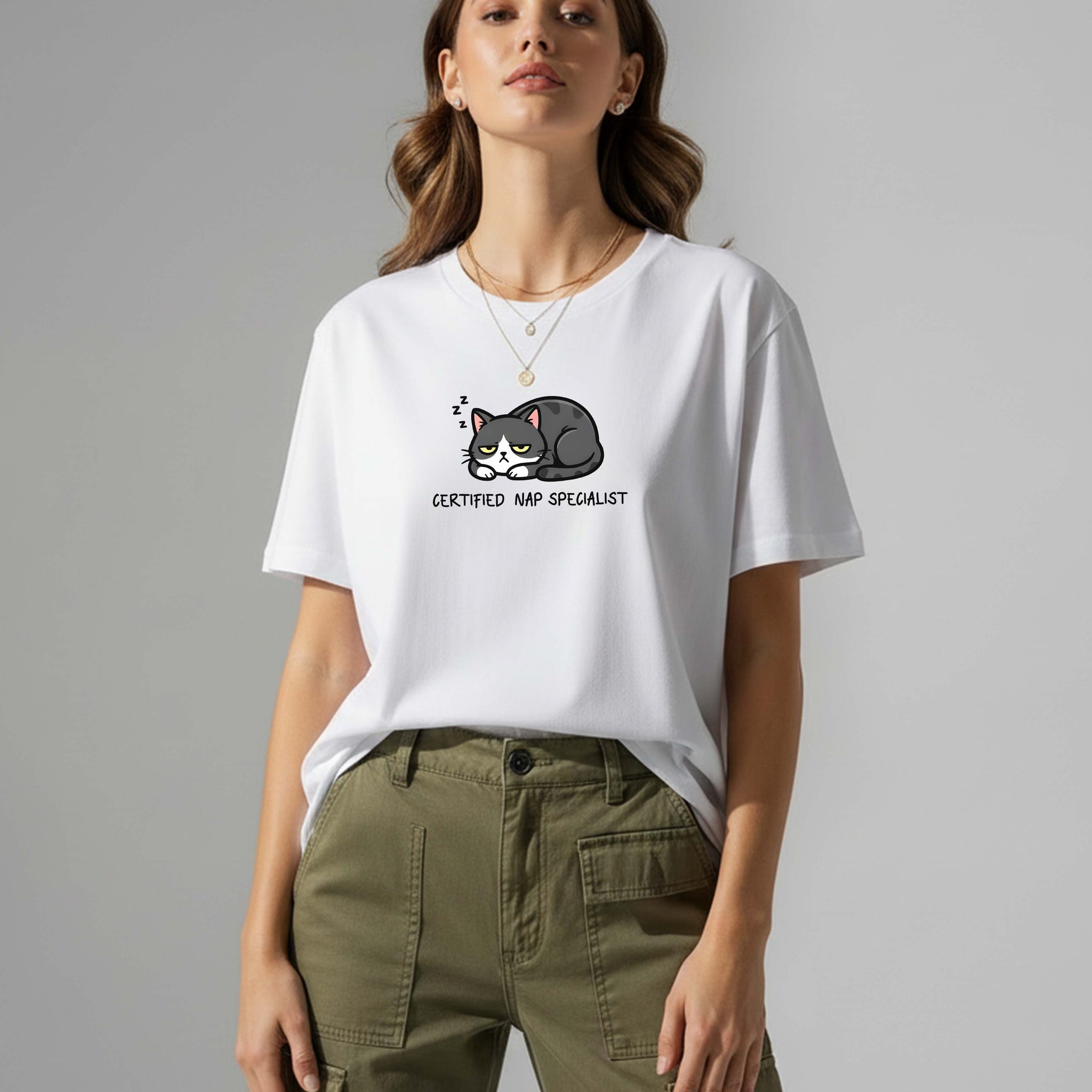 Woman wearing a white t-shirt with a cat graphic and text