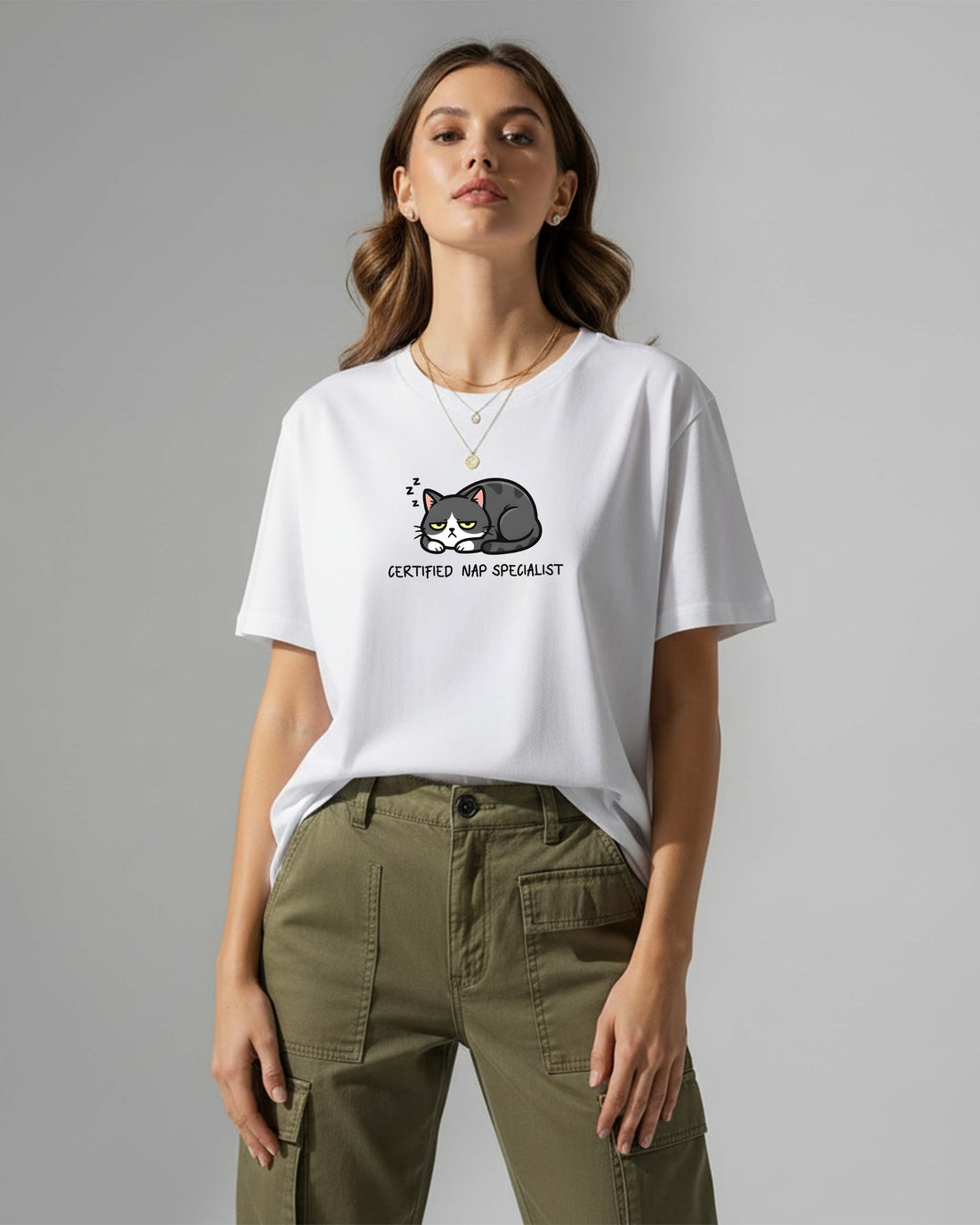 Woman wearing a white t-shirt with a cat graphic and text