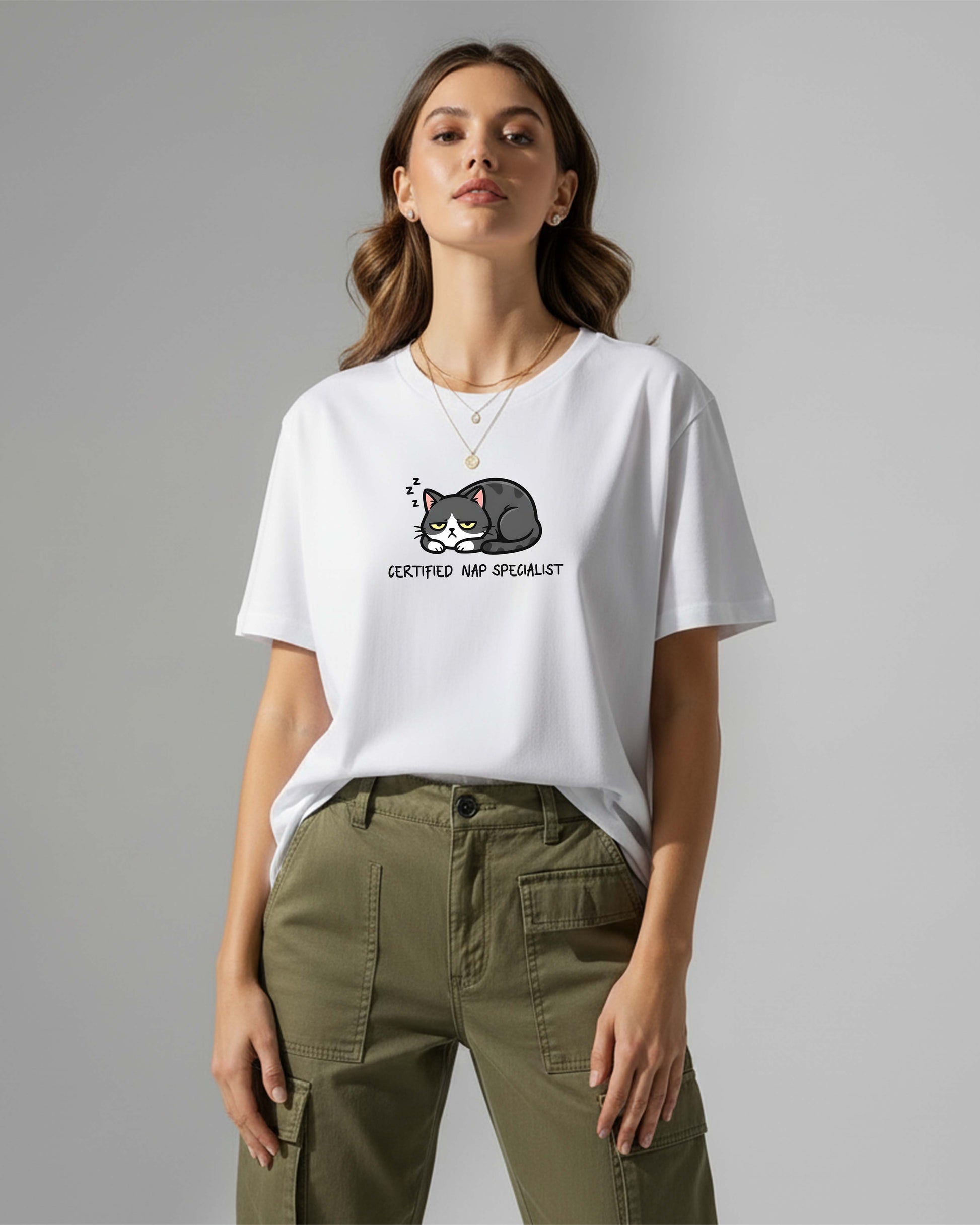 Woman wearing a white t-shirt with a cat graphic and text