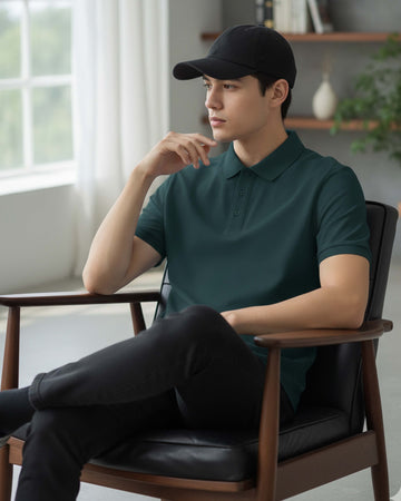 Man wearing a petrol blue polo shirt and black cap