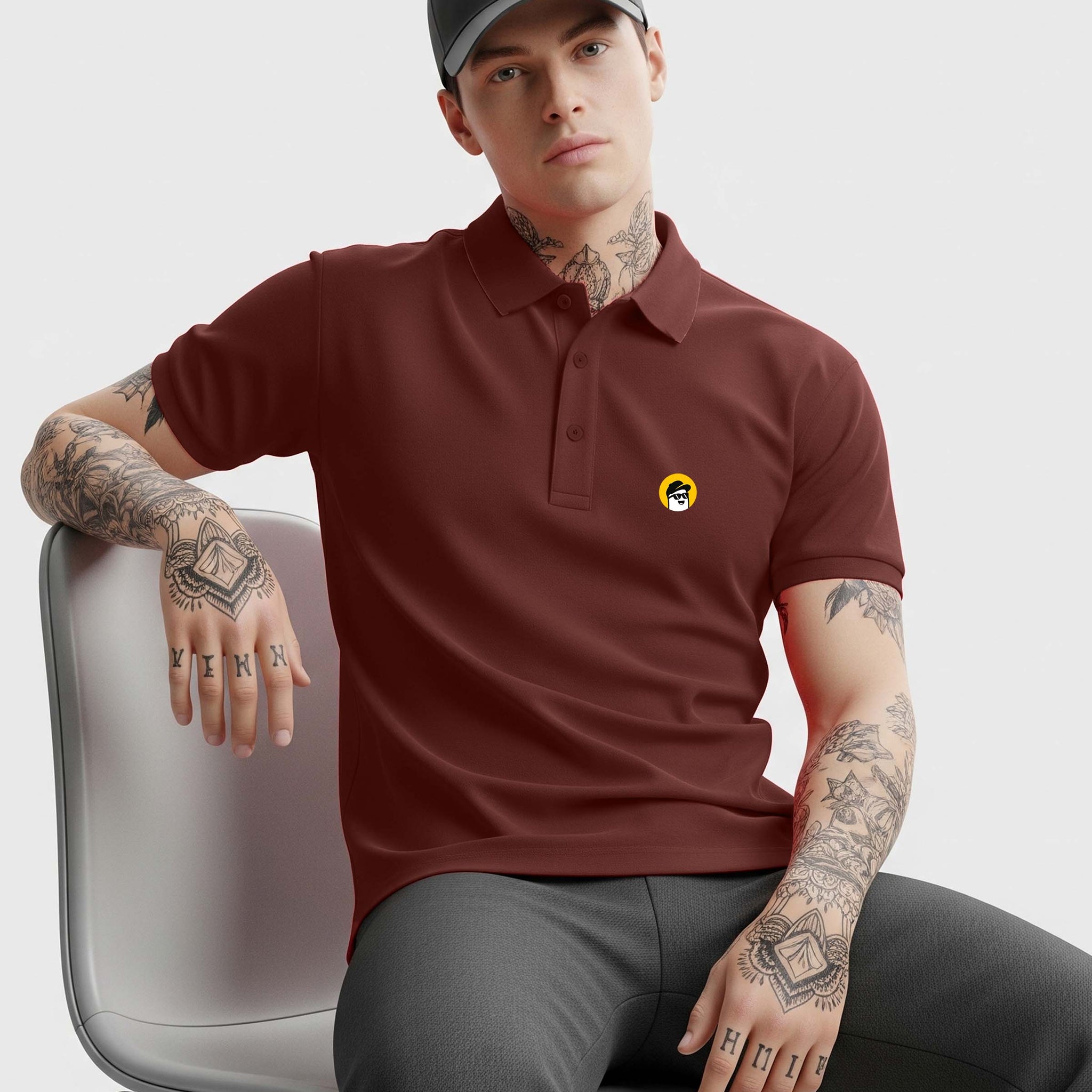 Man wearing a Dumkee brown polo shirt with a logo