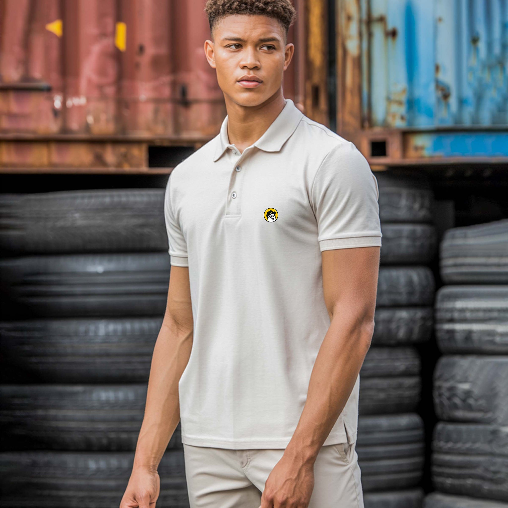 Person wearing a Dumkee light-colored polo shirt with a logo