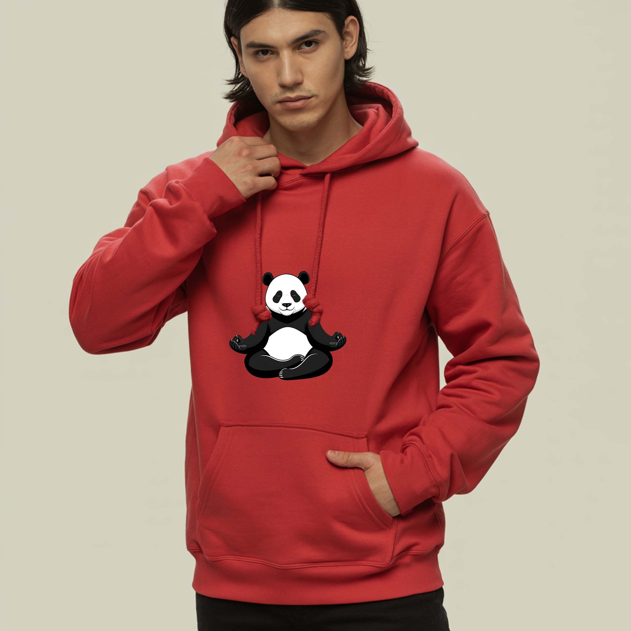 Person wearing a Dumkee red hoodie with a panda design on a beige background