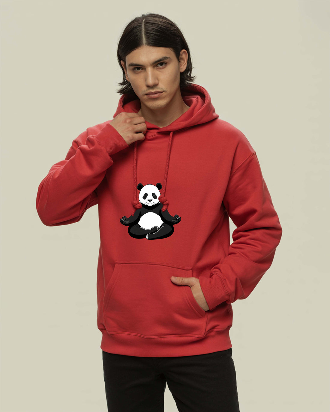 Person wearing a Dumkee red hoodie with a panda design on a beige background