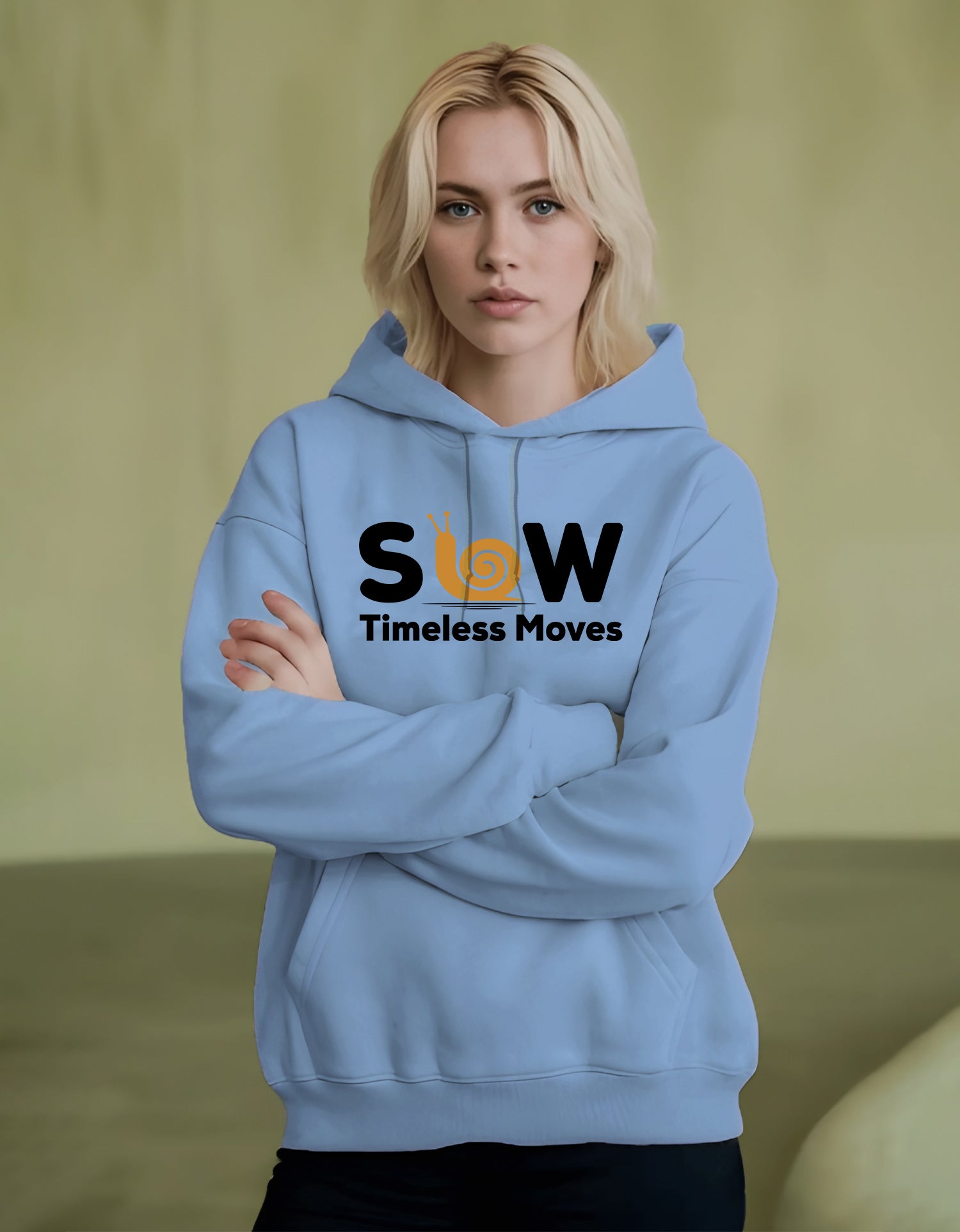 Person wearing a light blue hoodie with 'SLOW Timeless Moves' text on a green background