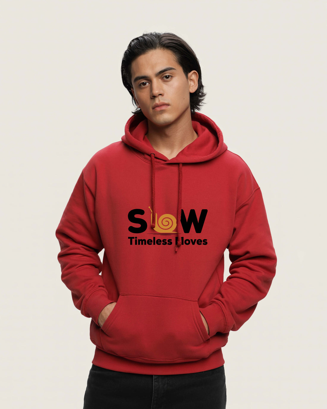 Person wearing a Dumkee Oversize red hoodie with 'SLOW Timeless Loves' text on a beige background