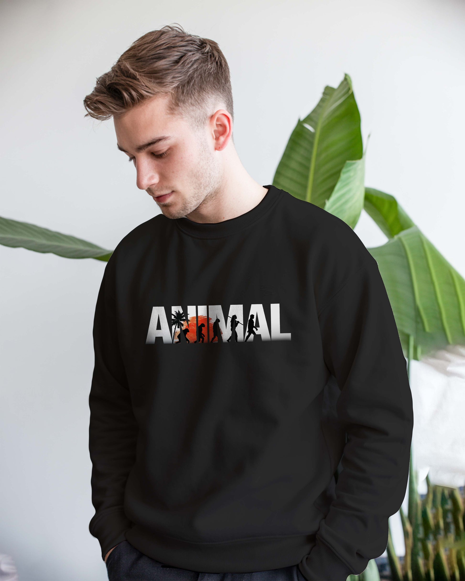 Person wearing a Dumkee black sweatshirt with 'ANIMAL' print on it.