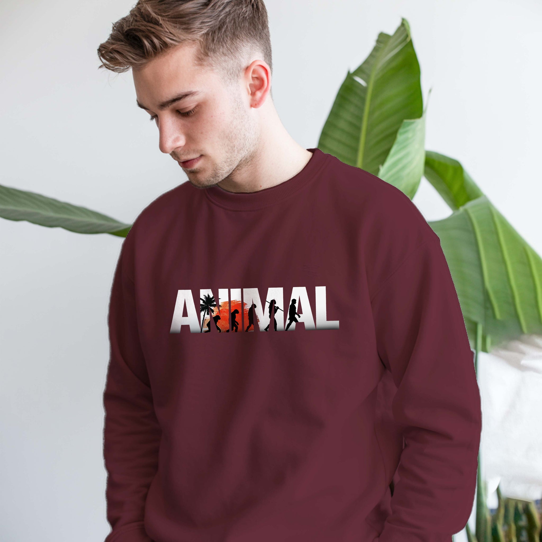 Man wearing a Dumkee maroon sweatshirt with 'ANIMAL' print on it.