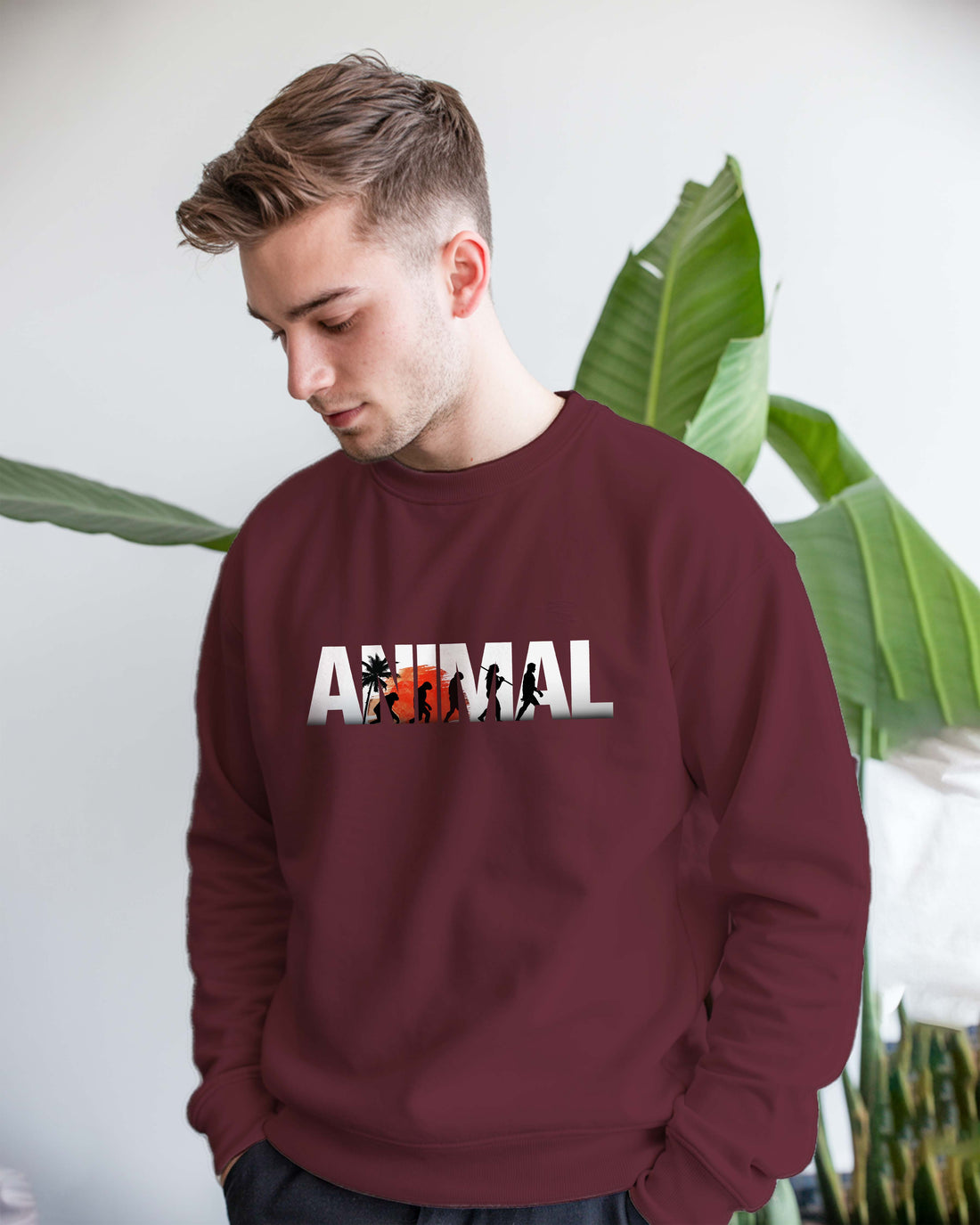 Man wearing a Dumkee maroon sweatshirt with 'ANIMAL' print on it.